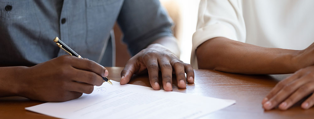 Couple signing a contract